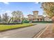 Building with a tower and manicured grounds, showcasing its unique architectural style at 142 Villa Di Este Ter # 204, Lake Mary, FL 32746
