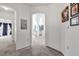 Neutral hallway with white walls, carpeting, and arched doorway, leading to the home's living spaces at 142 Villa Di Este Ter # 204, Lake Mary, FL 32746