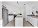 Open kitchen with white cabinets, stainless steel appliances, tile floors, and center island at 142 Villa Di Este Ter # 204, Lake Mary, FL 32746