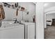 Functional laundry room equipped with modern washer and dryer units at 142 Villa Di Este Ter # 204, Lake Mary, FL 32746