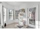 Bright room with windows, tile floors, and access to the exterior through a glass door at 142 Villa Di Este Ter # 204, Lake Mary, FL 32746