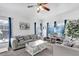 Bright living room featuring neutral furniture, a ceiling fan, and lots of sunlight at 142 Villa Di Este Ter # 204, Lake Mary, FL 32746