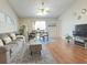 Cozy living room featuring hardwood floors, a comfortable sofa, and a dining table at 146 Brad Cir, Winter Haven, FL 33880