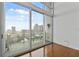 Bright room with expansive windows showcasing city views and access to the balcony at 150 E Robinson St # 1214, Orlando, FL 32801