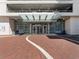 Inviting entrance featuring a glass canopy, brick paving, and well-placed benches for a welcoming atmosphere at 150 E Robinson St # 1214, Orlando, FL 32801