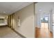 Hallway with carpeting leads to an apartment with hardwood floors and a balcony overlooking city views at 150 E Robinson St # 1214, Orlando, FL 32801