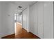 Hallway with wood floors and white closet doors leads to a room with a city view at 150 E Robinson St # 1214, Orlando, FL 32801