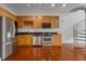 Well-lit kitchen featuring stainless steel appliances, wooden cabinets, and a spiral staircase at 150 E Robinson St # 1214, Orlando, FL 32801