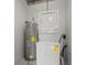This compact laundry area includes a stacked washer and dryer with a traditional water heater at 150 E Robinson St # 1214, Orlando, FL 32801