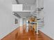 Open-concept living area with hardwood floors and a unique spiral staircase design at 150 E Robinson St # 1214, Orlando, FL 32801