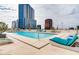 Rooftop pool and lounge chairs with skyscraper views at 150 E Robinson St # 1214, Orlando, FL 32801