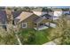Aerial view of the backyard featuring a covered patio, green lawn, and white fence, providing a peaceful retreat at 15174 Evergreen Oak, Winter Garden, FL 34787