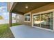 Covered back patio with sliding glass doors leading into the home at 15174 Evergreen Oak, Winter Garden, FL 34787