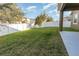 Expansive backyard with lush green grass and a pristine white fence, creating a serene and private outdoor space at 15174 Evergreen Oak, Winter Garden, FL 34787