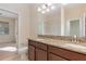 Bathroom view featuring a double sink vanity with granite countertops and a glimpse of the shower at 15174 Evergreen Oak, Winter Garden, FL 34787