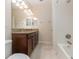 Bright bathroom featuring tile floors, double sink vanity with granite countertop and shower over tub at 15174 Evergreen Oak, Winter Garden, FL 34787