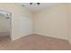 Bedroom with tan carpet and neutral walls, features access door to another room and double closet at 15174 Evergreen Oak, Winter Garden, FL 34787