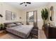 Comfortable bedroom featuring neutral tones, decorative artwork, and a large leafy plant at 15174 Evergreen Oak, Winter Garden, FL 34787