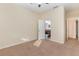 Neutral bedroom showcasing carpet, cream walls, a bathroom view, and good natural light at 15174 Evergreen Oak, Winter Garden, FL 34787