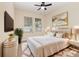 Staged bedroom with a cozy bed, stylish decor, and abundant natural light from the windows at 15174 Evergreen Oak, Winter Garden, FL 34787