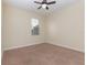 Well-lit bedroom featuring neutral carpet and walls with a ceiling fan and a bright window at 15174 Evergreen Oak, Winter Garden, FL 34787