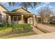 Home showcasing a cozy front porch, manicured landscaping, and a welcoming facade at 15174 Evergreen Oak, Winter Garden, FL 34787