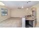 Granite countertops with an open view to the living room in this neutral home at 15174 Evergreen Oak, Winter Garden, FL 34787
