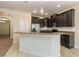 Kitchen featuring dark wood cabinets, granite countertops, and stainless-steel appliances at 15174 Evergreen Oak, Winter Garden, FL 34787