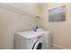 Practical laundry room equipped with modern washer and dryer, storage shelves, and natural light at 15174 Evergreen Oak, Winter Garden, FL 34787