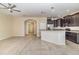 Spacious living room flows into a kitchen with dark cabinets and granite counters at 15174 Evergreen Oak, Winter Garden, FL 34787