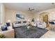 Staged living room featuring a stylish seating area, an area rug, and ample natural light at 15174 Evergreen Oak, Winter Garden, FL 34787
