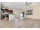 Open-concept living room and kitchen boasts sleek flooring and stainless steel appliances at 15174 Evergreen Oak, Winter Garden, FL 34787