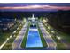 Scenic night view features a beautifully lit building, symmetrical street layout, and pond at 15174 Evergreen Oak, Winter Garden, FL 34787