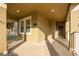 Inviting covered front porch with neutral tones, brick flooring, and space for relaxing at 15174 Evergreen Oak, Winter Garden, FL 34787