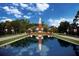 A scenic reflection pond mirroring a clock tower and surrounding buildings at 15174 Evergreen Oak, Winter Garden, FL 34787