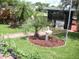 Serene backyard oasis with lush landscaping, charming birdbath, and a peaceful waterfront view at 1522 S Shore Dr, Tavares, FL 32778