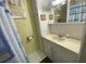 Small bathroom with white cabinets, framed wall art and a shower curtain at 1522 S Shore Dr, Tavares, FL 32778