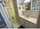 Small bathroom with white cabinets, framed wall art and a shower curtain at 1522 S Shore Dr, Tavares, FL 32778