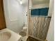 A bright full bathroom with walk-in shower and neutral color scheme at 1522 S Shore Dr, Tavares, FL 32778