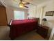 Cozy bedroom featuring a bed, a wood nightstand and natural light at 1522 S Shore Dr, Tavares, FL 32778