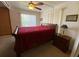 Cozy bedroom featuring a bed, a wood nightstand and natural light at 1522 S Shore Dr, Tavares, FL 32778