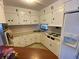 Well-lit kitchen with white cabinets, stainless steel sink, and ample counter space at 1522 S Shore Dr, Tavares, FL 32778