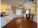 An open living room with wood floors, lots of natural light and a ceiling fan at 1522 S Shore Dr, Tavares, FL 32778