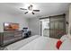 Bedroom with sleek workstation, dresser, and a sliding barn door leading to an ensuite bathroom at 153 Illinois Ave, Babson Park, FL 33827