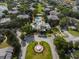 Community aerial view showcasing pool, clubhouse, lush landscaping, and winding roads between residential buildings at 167 Villa Di Este Ter Ter # 213, Lake Mary, FL 32746