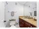 Cozy bathroom features a single vanity with granite countertop and a decorative mirror at 167 Villa Di Este Ter Ter # 213, Lake Mary, FL 32746