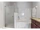 Bright bathroom features a shower and tub combination with a decorative glass door and granite countertop at 167 Villa Di Este Ter Ter # 213, Lake Mary, FL 32746