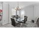 Bright dining room features a glass table, leather chairs, and wood-look floors at 167 Villa Di Este Ter Ter # 213, Lake Mary, FL 32746