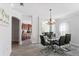 Bright dining room features a glass table, leather chairs, and wood-look floors at 167 Villa Di Este Ter Ter # 213, Lake Mary, FL 32746
