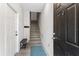 Inviting entryway with a staircase, light wood floors and a black front door at 167 Villa Di Este Ter Ter # 213, Lake Mary, FL 32746
